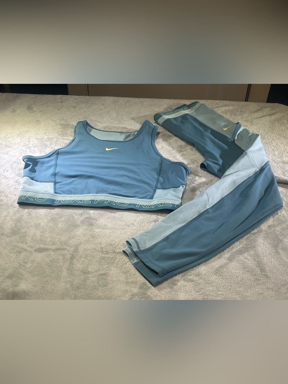 Nike Women's Light Blue Athletic Tank Top with Yellow Swoosh